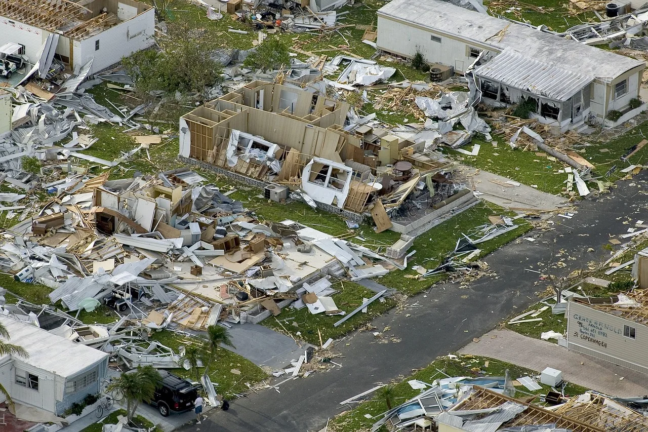 Wind damage to private homes after the hurricane swept through the Florida mobile home residential area. Consequences of the natural disaster.